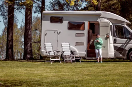 Ganzjährig geöffnete Campingplätze: Frau mit Camperwagen auf einem ganzjährig geöffneten Campingplatz