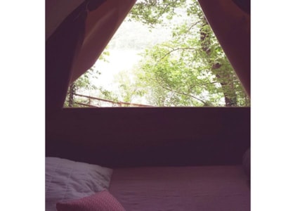 Bivouac hut on stilts under the trees